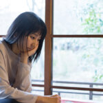 Portrait of an Asian woman at a window